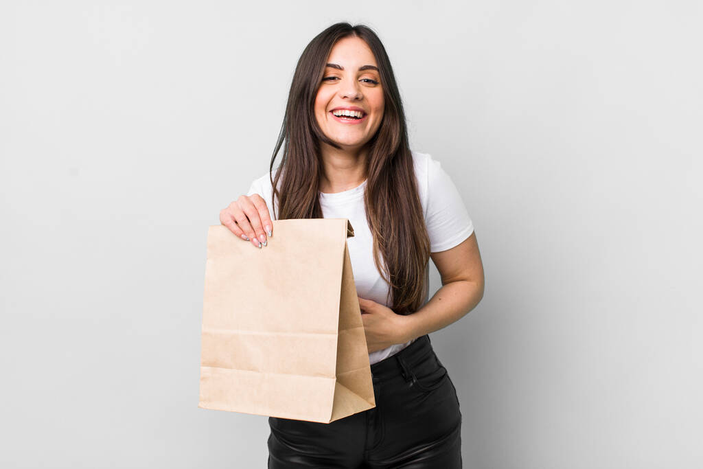 young pretty woman laughing out loud at some hilarious joke. take away food concept - Fotoğraf, Görsel
