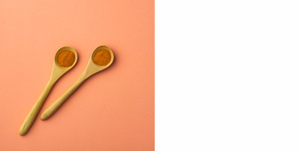 Healthy turmeric powder in two wooden spoons - Curcuma longa - Foto, immagini