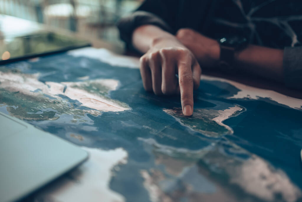 Travelers planning trips and finger pointing on map, or find travel routes. Travel concept. - Photo, Image