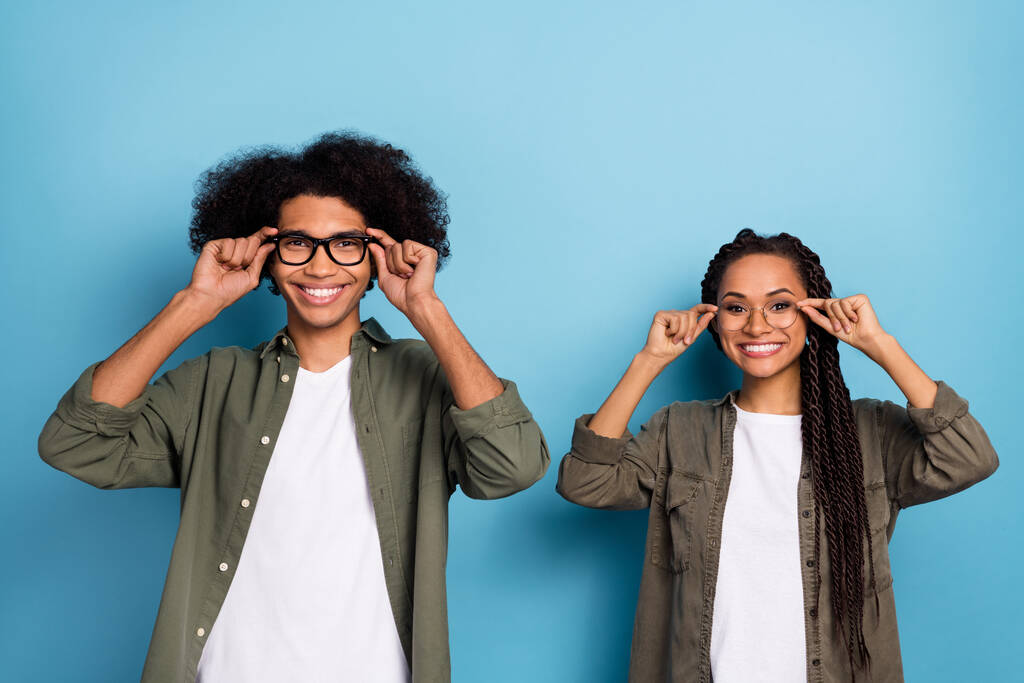 Photo of two workers guy lady touch specs enjoy eyesight treatment wear stylish trendy shirt isolated blue color background - Photo, image