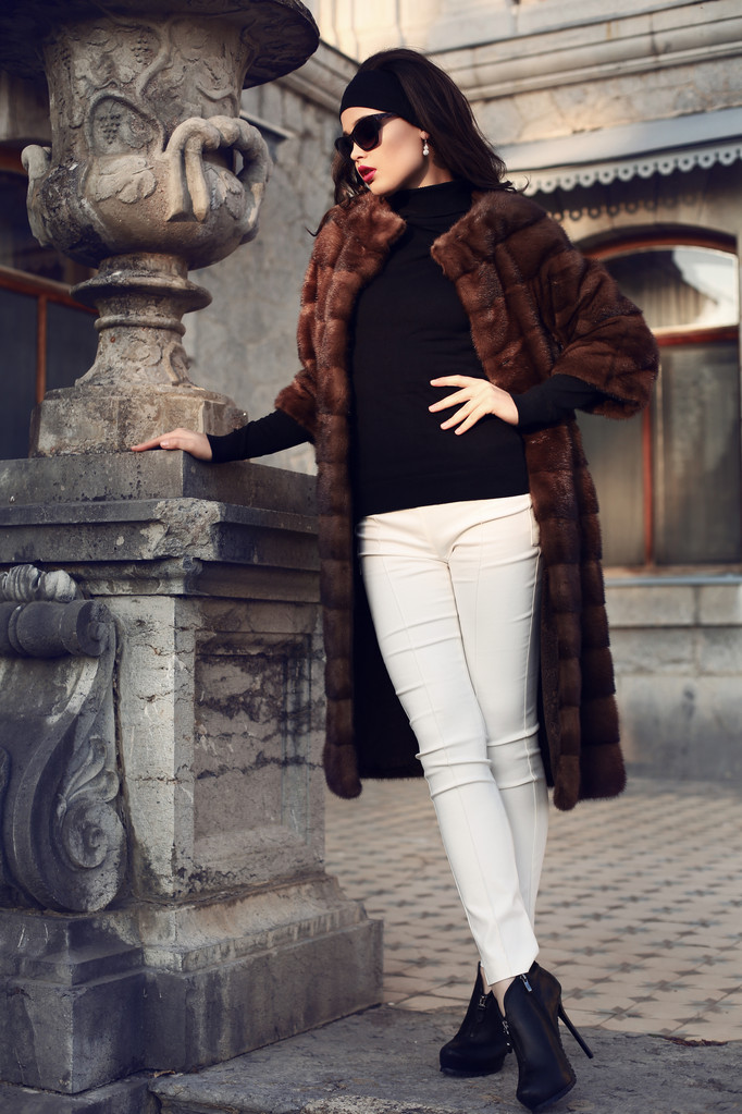 beautiful elegant woman in luxurious fur coat posing in castle - Photo, Image