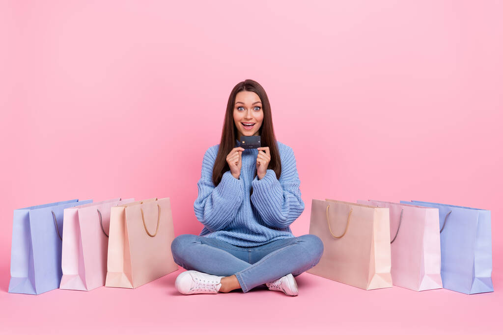 full size foto di impressionato giovane bruna signora fare shopping usura maglione jeans scarpe isolato su sfondo rosa - Foto, immagini