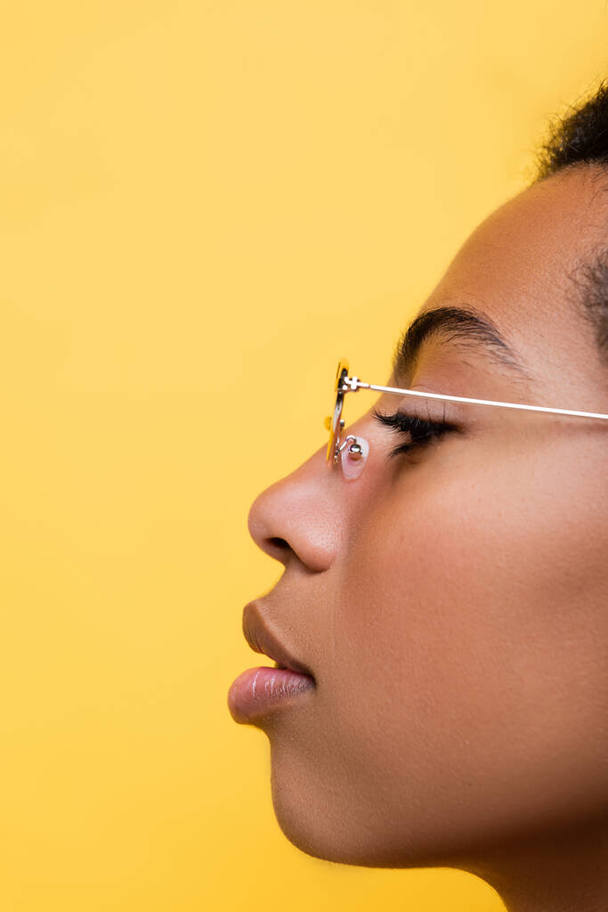 黄色で隔絶された眼鏡をかけたアフリカ系アメリカ人女性のプロフィール - 写真・画像