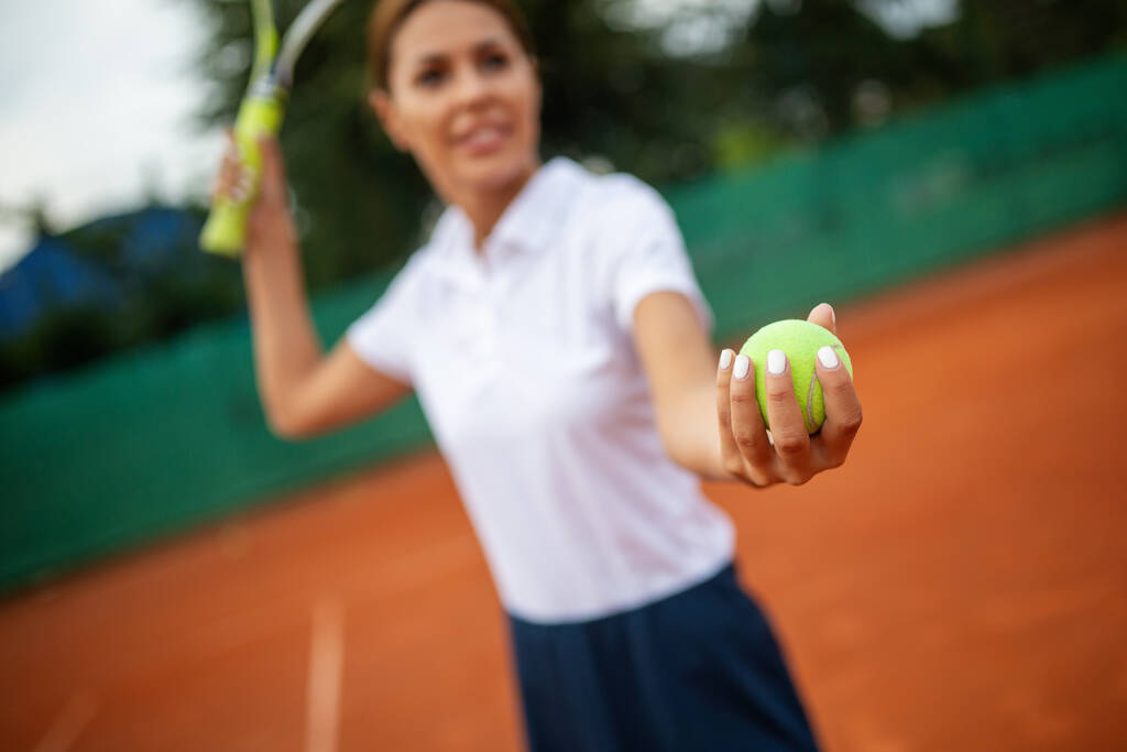 Portrait of happy fit young woman playing tennis at summer. People sport healthy lifestyle concept - Photo, Image
