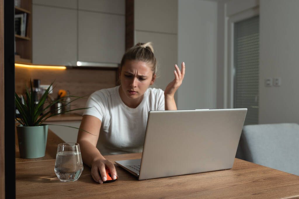 Young college or freelancer business woman working from home have issue with broken computer mouse for her laptop. Female can't do her homework because her mouse not working. Selective focus - Photo, Image