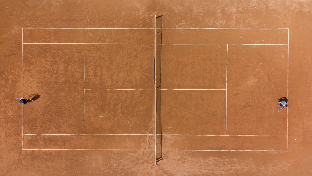 View from above, aerial top view of two people playing tennis on a clay court - Photo, Image