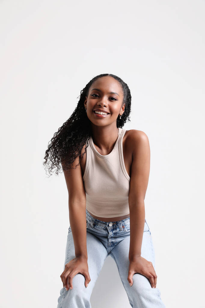 Vertical portrait of happy young woman posing and smiling at the studio. . High quality photo. - Photo, Image