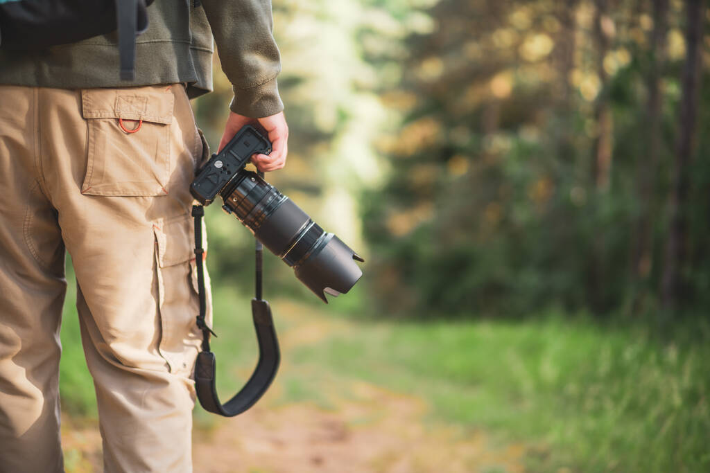 Imagen del hombre fotografiando mientras camina en la naturaleza. - Foto, imagen