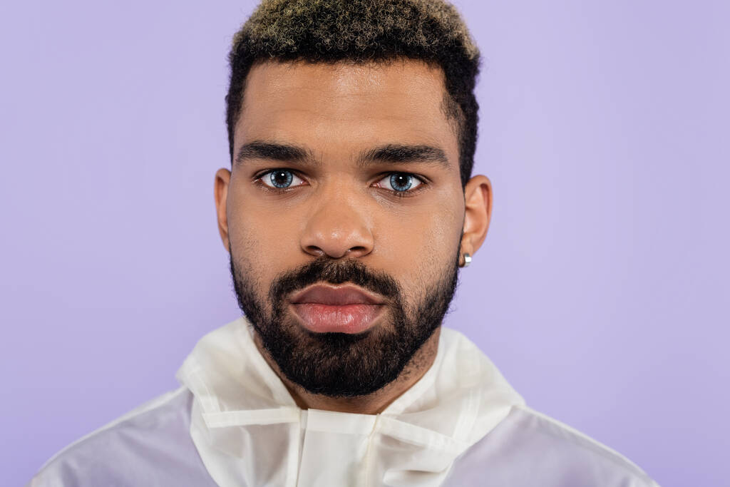 portrait of bearded african american man with blue eyes isolated on purple  - Photo, Image