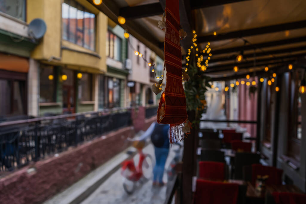 Garlands on blurred outdoor cafe on urban street in Wroclaw - Photo, Image