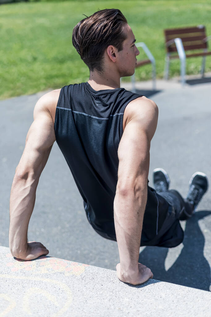 Фитнес-человек делает скамейку трицепсы погружения во время тренировки на открытом воздухе кросс. - Фото, изображение