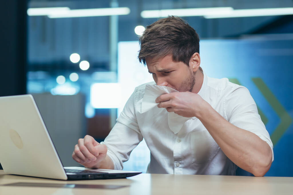 Businessman working in the office has a seasonal allergy sneezes - Photo, Image