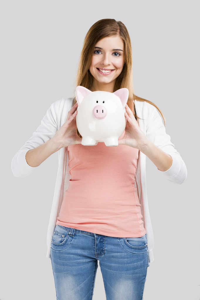 Blonde woman with a piggy bank - Photo, Image
