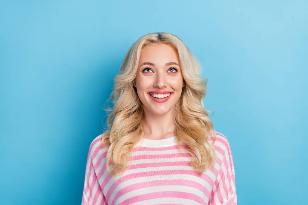 Photo of lovely young blond hairdo lady look up wear pink shirt isolated on blue color background. - Photo, Image