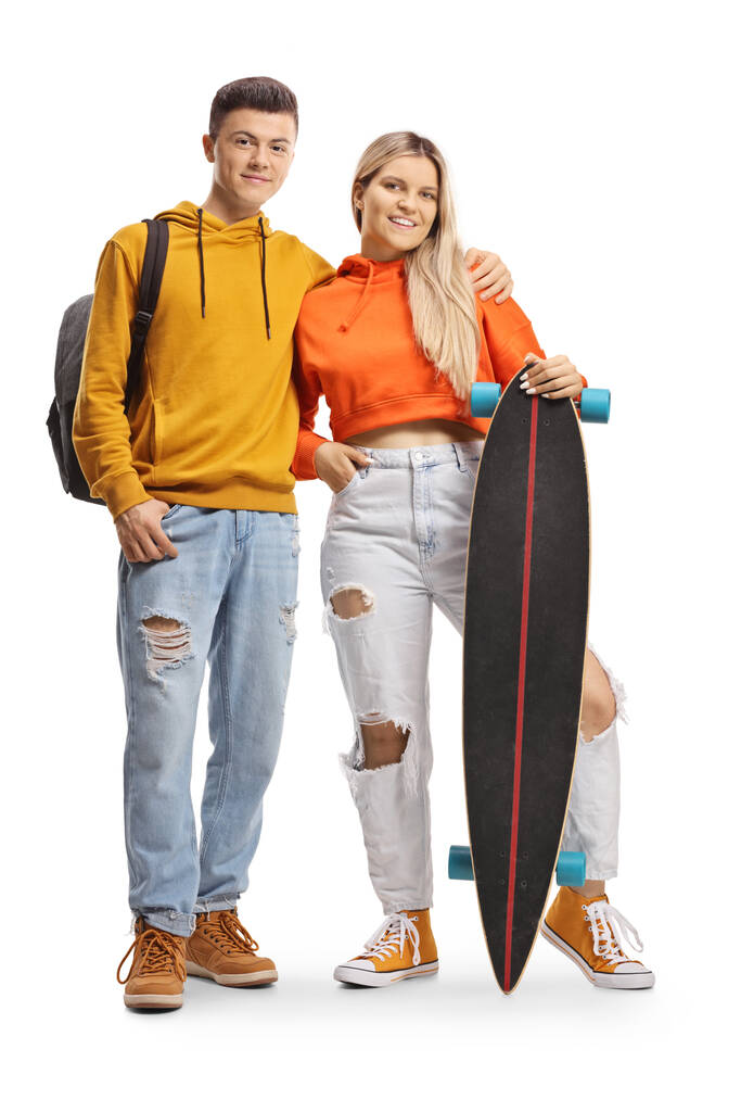 Trendy young male and female with a longboard isolated on white background - Photo, Image