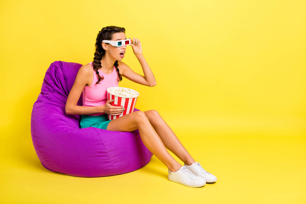 Full body profile side photo of amazed woman wear 3d glasses watch movie bean bag ear pop corn isolated on yellow color background. - Photo, Image