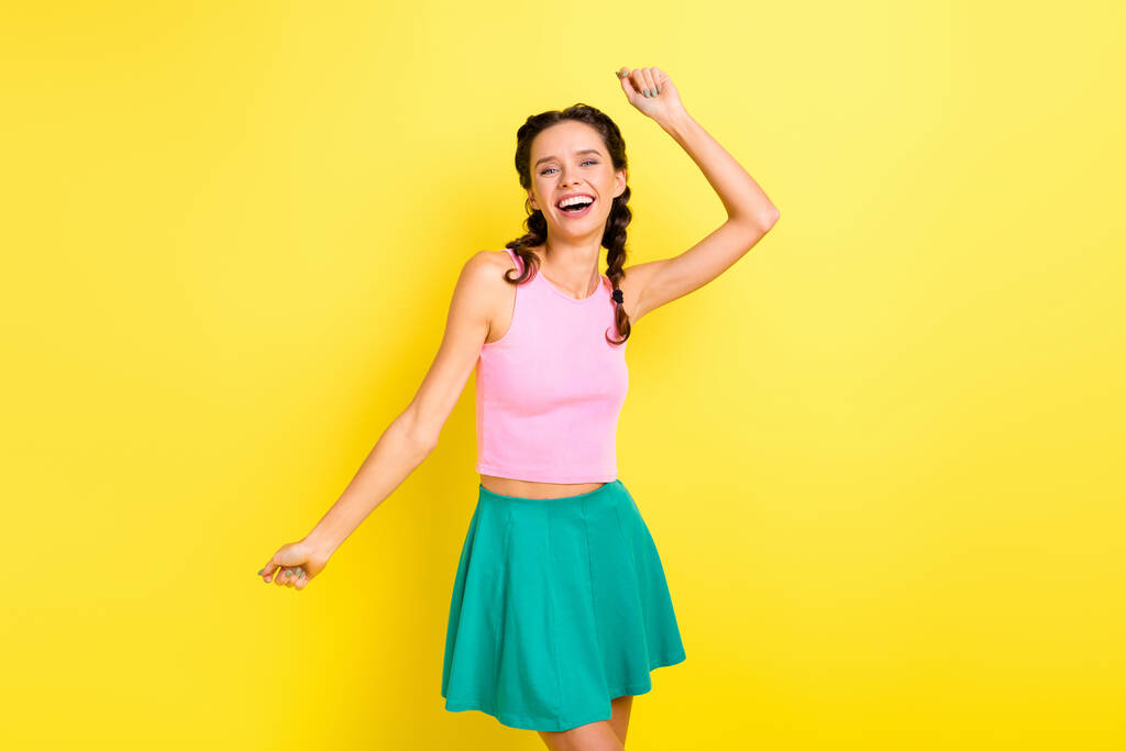 Photo of charming sweet young woman pigtails wear tank top dancing smiling isolated yellow color background. - Photo, Image