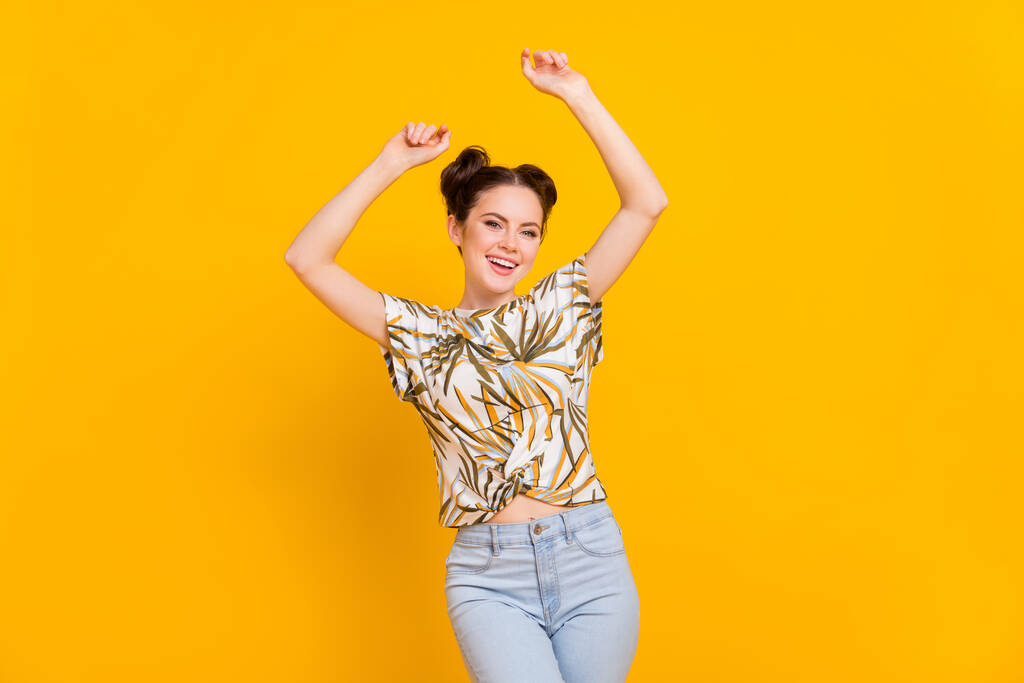 Photo of positive adorable lady dressed print t-shirt having fun smiling isolated yellow color background. - Photo, Image
