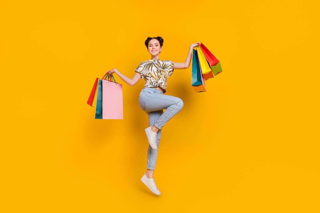 Photo of dreamy funny lady dressed print t-shirt running fast jumping high rising bargains isolated yellow color background. - Photo, Image