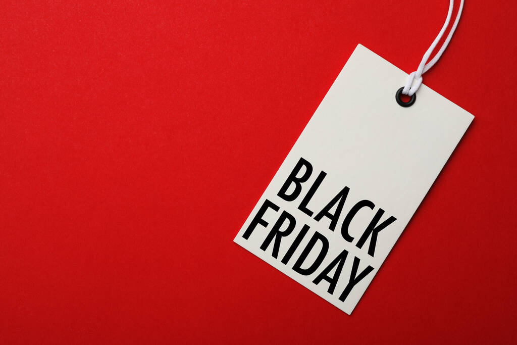 White tag with phrase BLACK FRIDAY on red background, top view. Space for text - Photo, Image