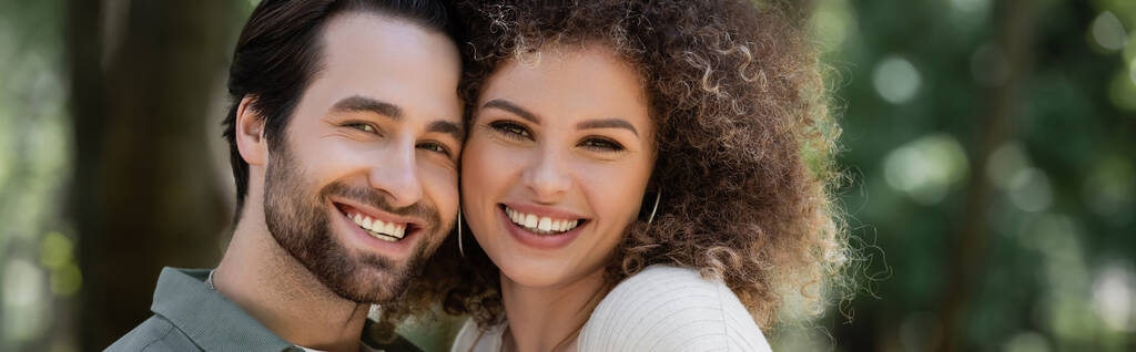 portrait of cheerful young couple smiling and looking at camera, banner - Foto, imagen