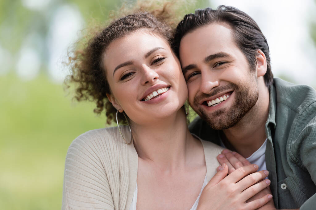 portrait of pleased woman and happy bearded man looking at camera - Photo, Image