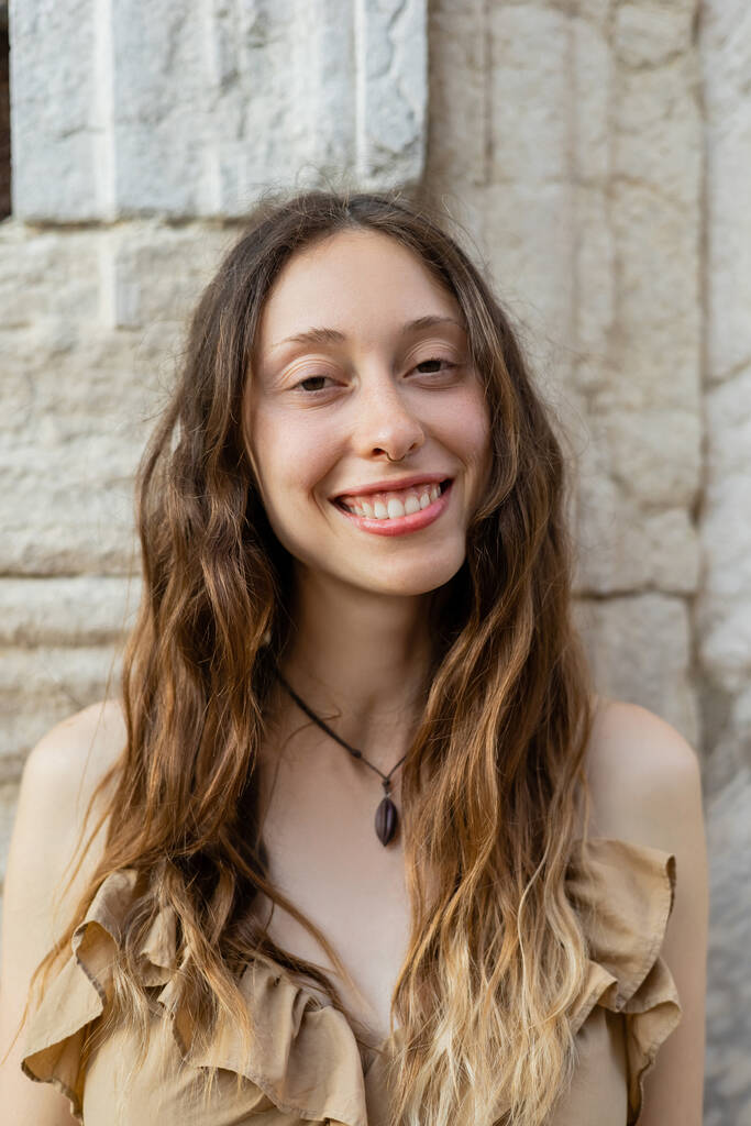 Portrait of young brunette woman smiling at camera in Venice  - Photo, image