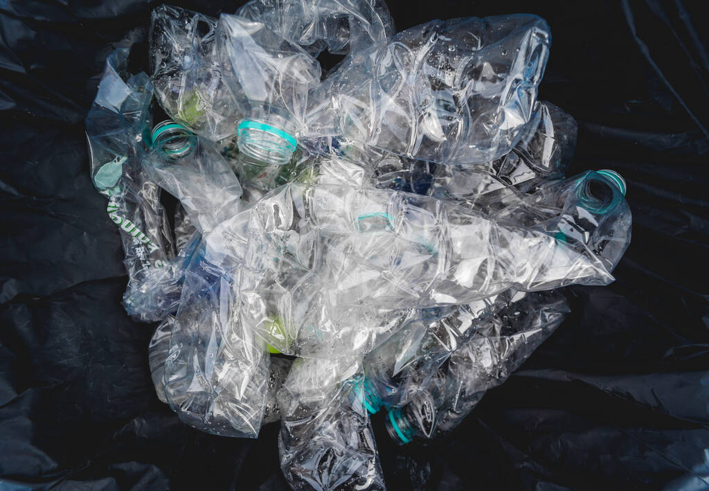 Large bags with collected plastic and other waste on the beach. - Photo, image