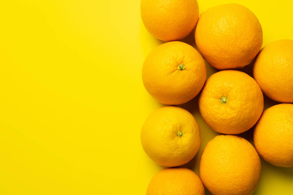Top view of sweet oranges on yellow background with copy space - Foto, Imagen