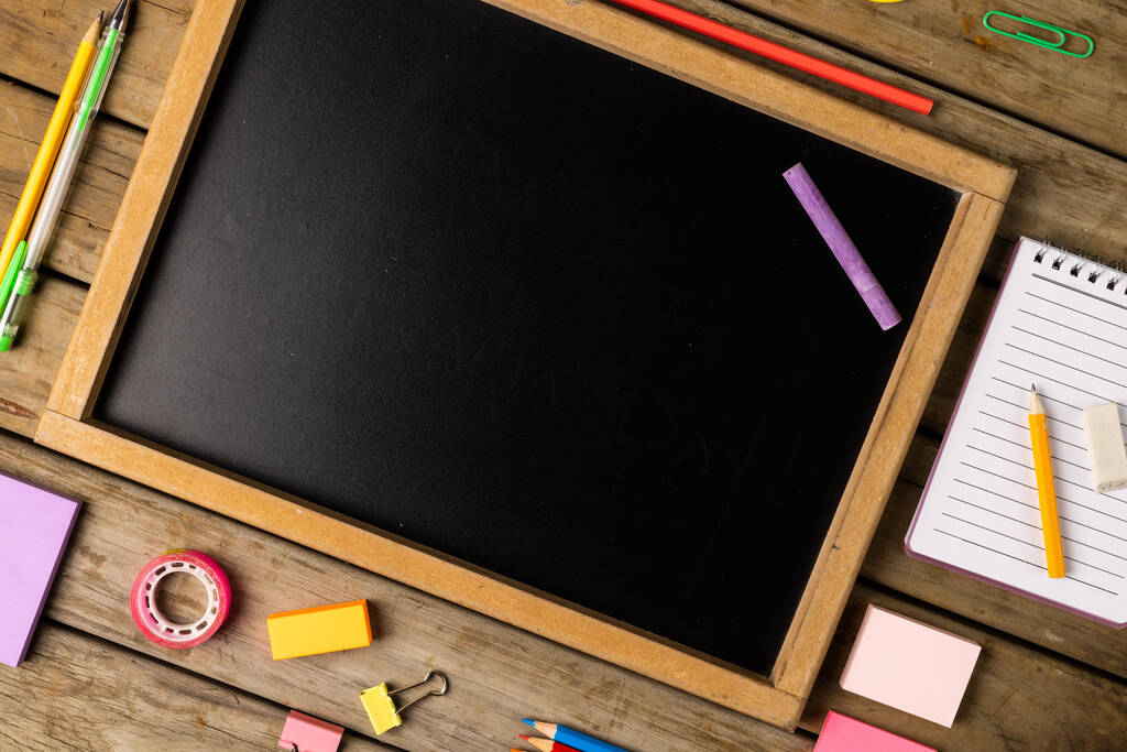Composition of blackboard with copy space and school items on wooden background. School equipment, tools, learning and creativity concept. - Zdjęcie, obraz
