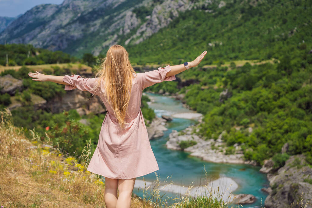 Woman tourist on background of purest waters of the turquoise color of the river Moraca flowing among the canyons. Travel around Montenegro concept. - Foto, Imagen