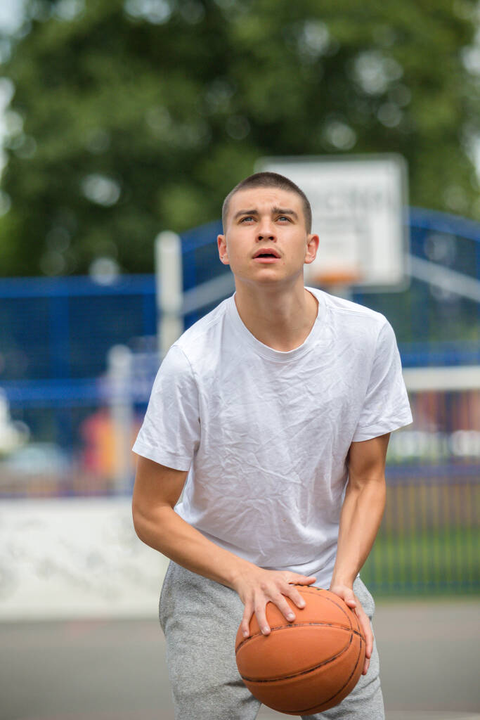 A Nineteen Year Old Teenage Boy Playing Basketball in A Public Park - Fotó, kép