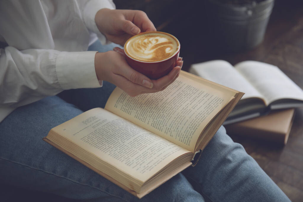Nő csésze kávé olvasókönyv beltéri, közelkép - Fotó, kép