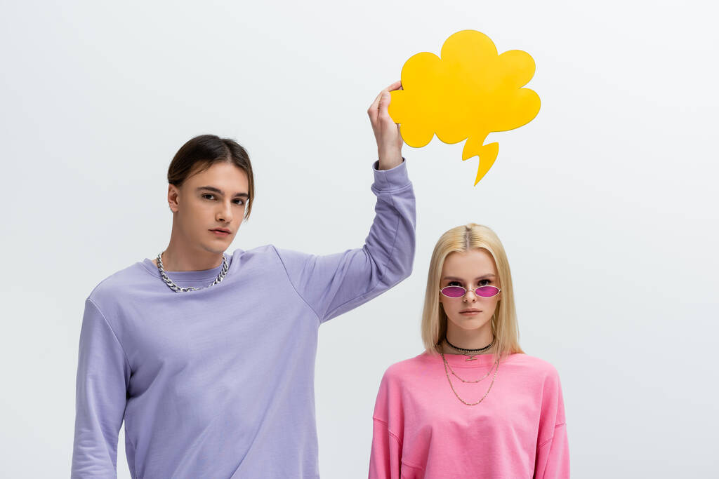 Young man holding thought bubble above girlfriend in sunglasses isolated on grey  - Φωτογραφία, εικόνα