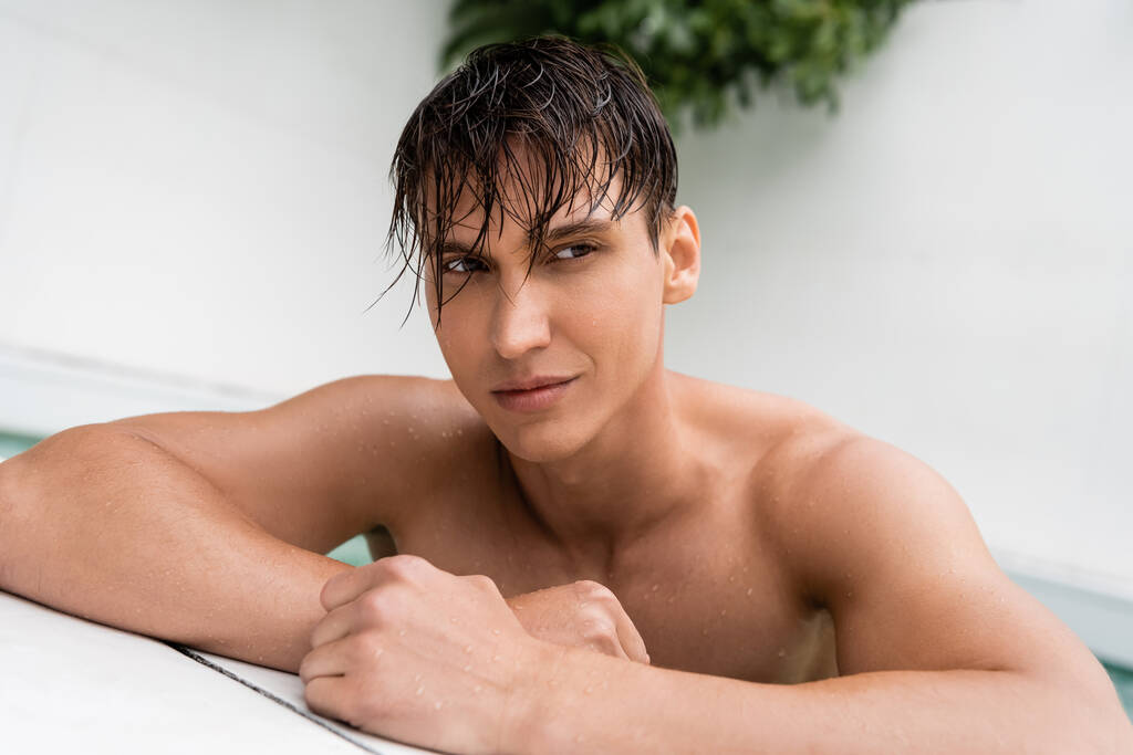 férfi sportos test és nedves haj néz félre medence mellett - Fotó, kép
