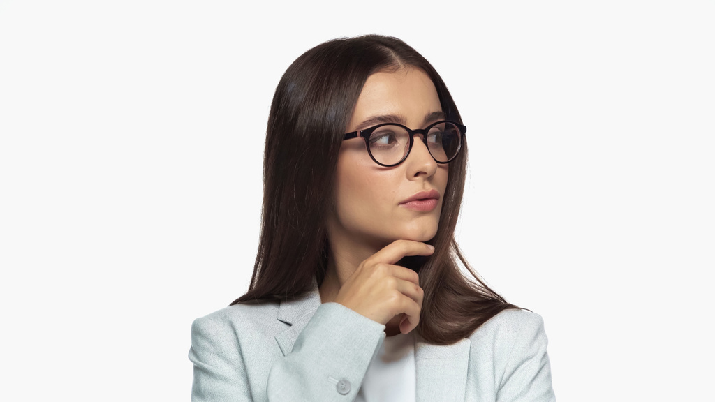 curious businesswoman in grey blazer and eyeglasses looking away isolated on white - Fotoğraf, Görsel