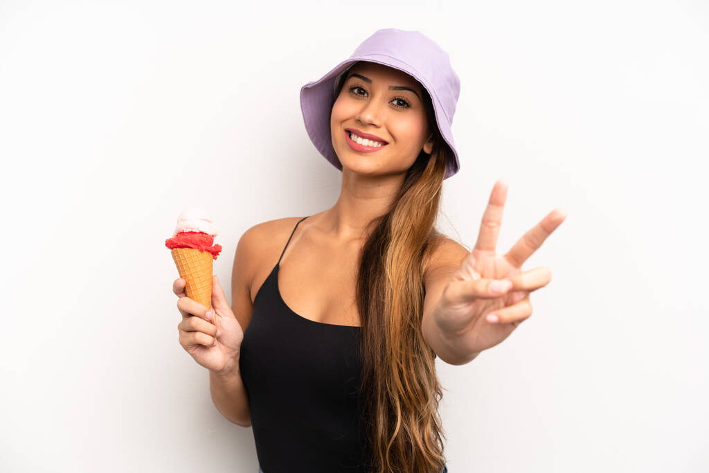 asian young woman smiling and looking friendly, showing number two. summer and ice cream concept - Zdjęcie, obraz