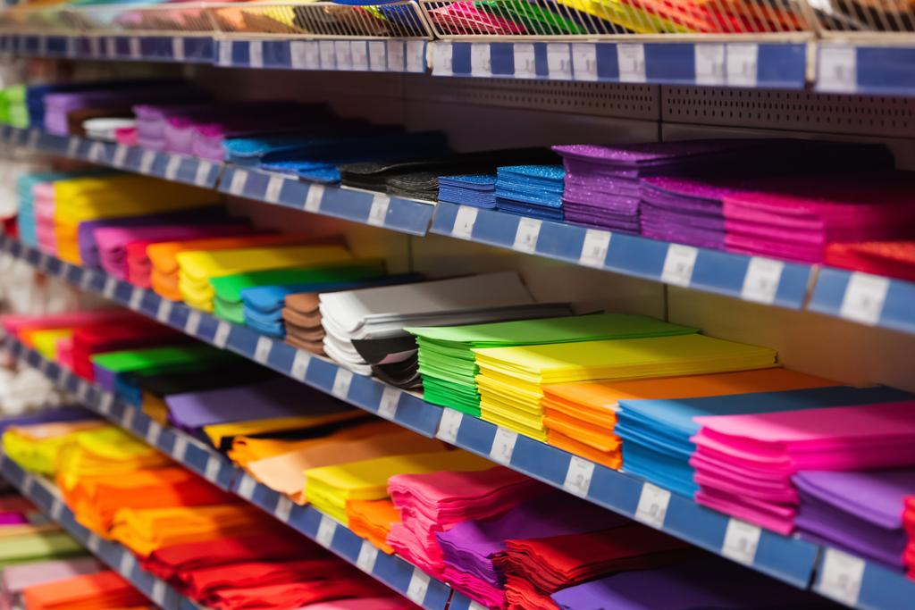 rack with multicolored plastic files and folders in stationery store - Foto, immagini