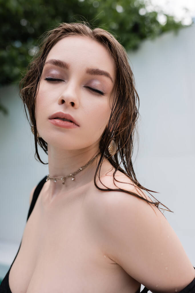 Portrait of stylish woman with wet hair closing eyes at resort  - Fotografie, Obrázek