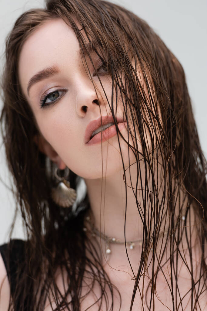 Portré fiatal nő smink és nedves haj nézi kamera szabadban  - Fotó, kép
