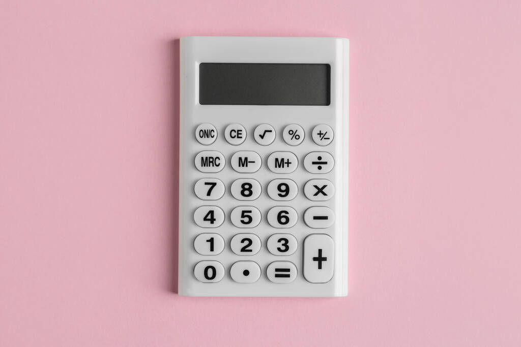 Білий калькулятор на рожевому фоні, вид зверху
 - Фото, зображення