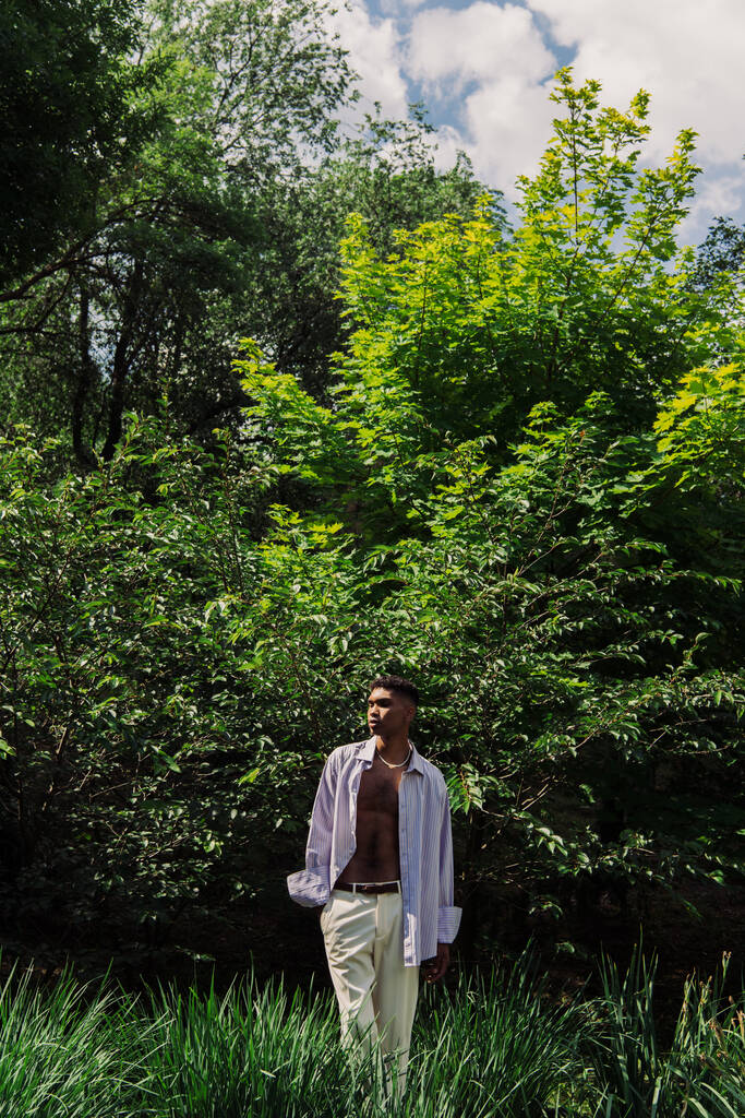 mladý africký Američan v létě oblečení stojící s rukou v kapse v letním parku - Fotografie, Obrázek