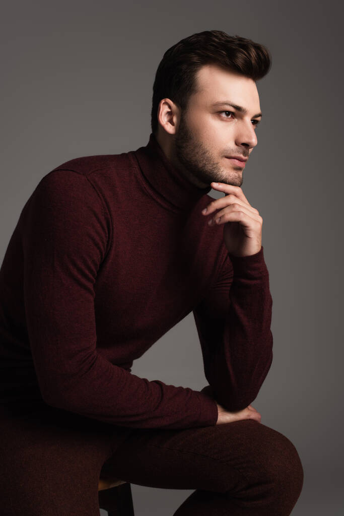 Young man in turtleneck looking away isolated on grey  - Foto, imagen