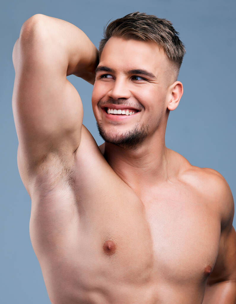 Genetically blessed, groomed by choice. Studio shot of a muscular young man posing against a grey background - Foto, imagen