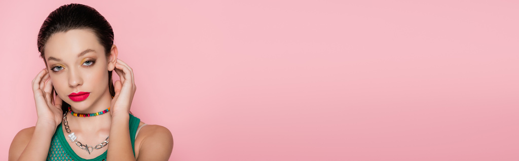 pretty young woman with bright makeup looking at camera isolated on pink, banner - Photo, Image