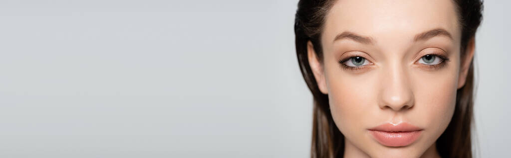 close up view of young woman with blue eyes and makeup isolated on grey, banner - Photo, Image