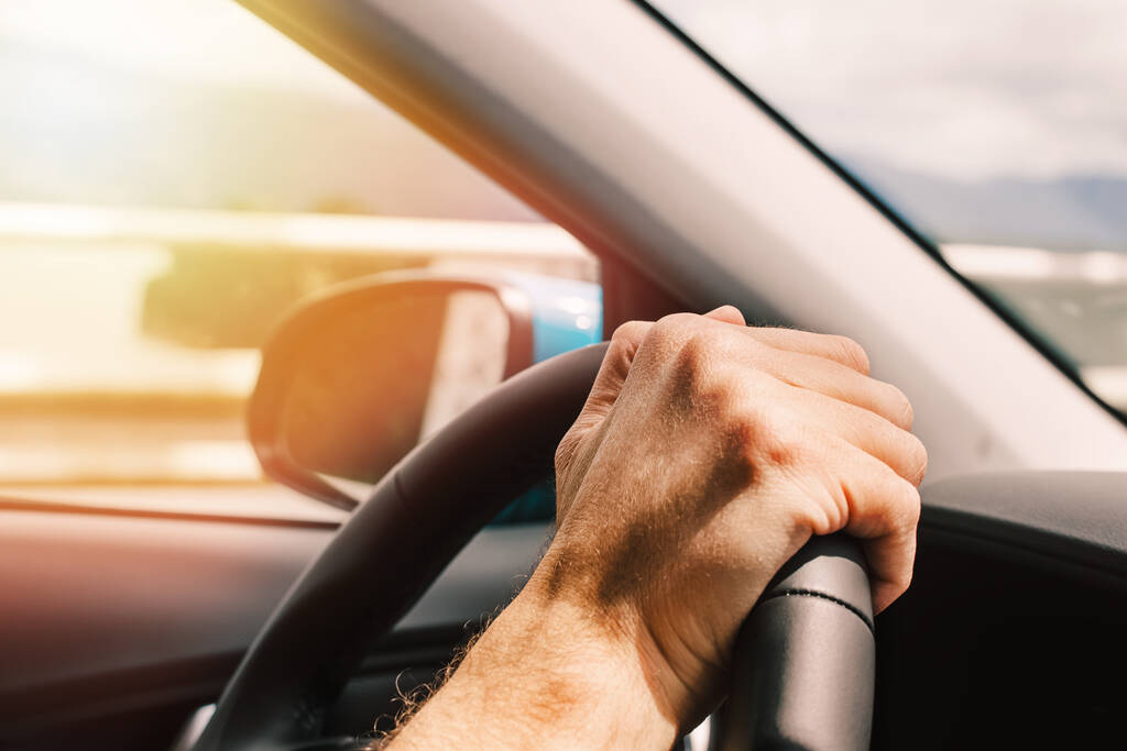 Man's hand on the steering wheel close-up, man driving a car - Foto, imagen