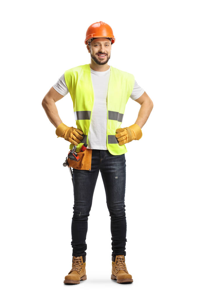 Full length portrait of a site engineer wearing a tool belt and smiling at camera isolated on white background - Fotoğraf, Görsel