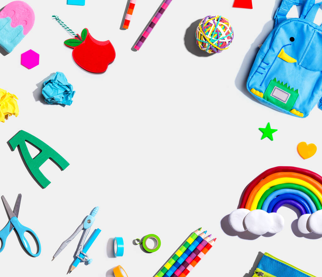 School supplies with a rainbow - overhead view - flat lay - 写真・画像