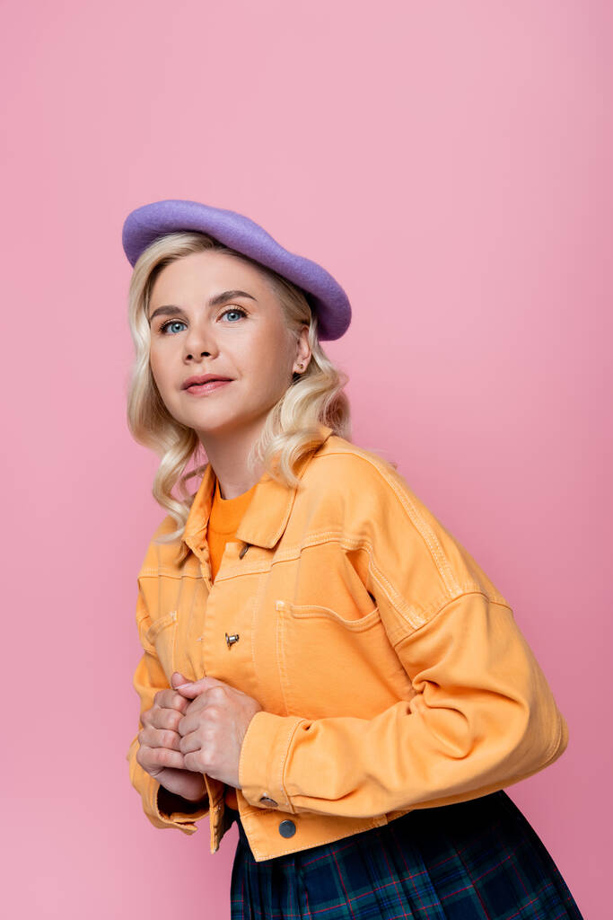 Portrait of stylish blonde woman in beret looking at camera isolated on pink  - Photo, image